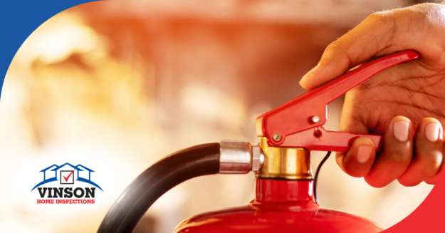 Vinson Home Inspections (4) Close-up of a hand operating a red fire extinguisher