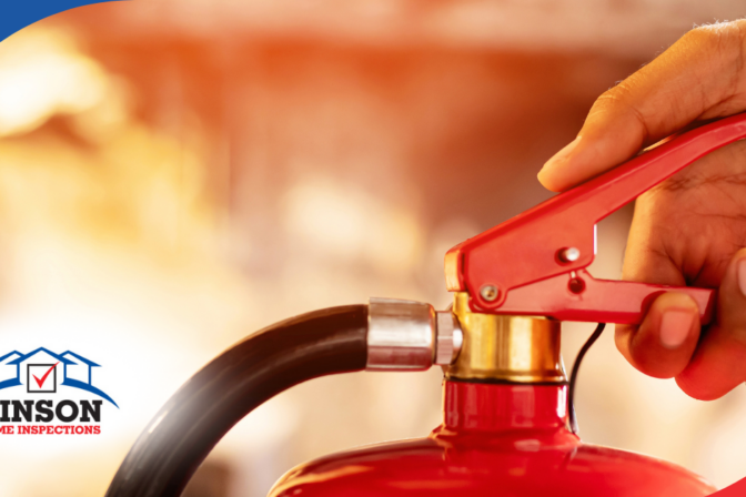 Vinson Home Inspections (4) Close-up of a hand operating a red fire extinguisher