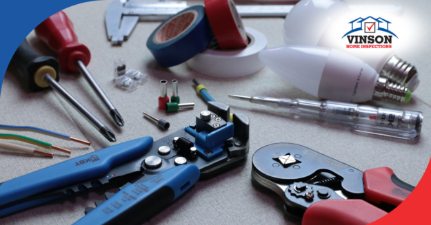 Vinson Home Inspections Electrical tools, wires, and light bulbs arranged on a work surface for inspection tasks.