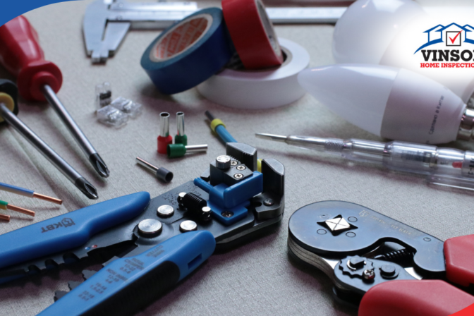 Vinson Home Inspections Electrical tools, wires, and light bulbs arranged on a work surface for inspection tasks.