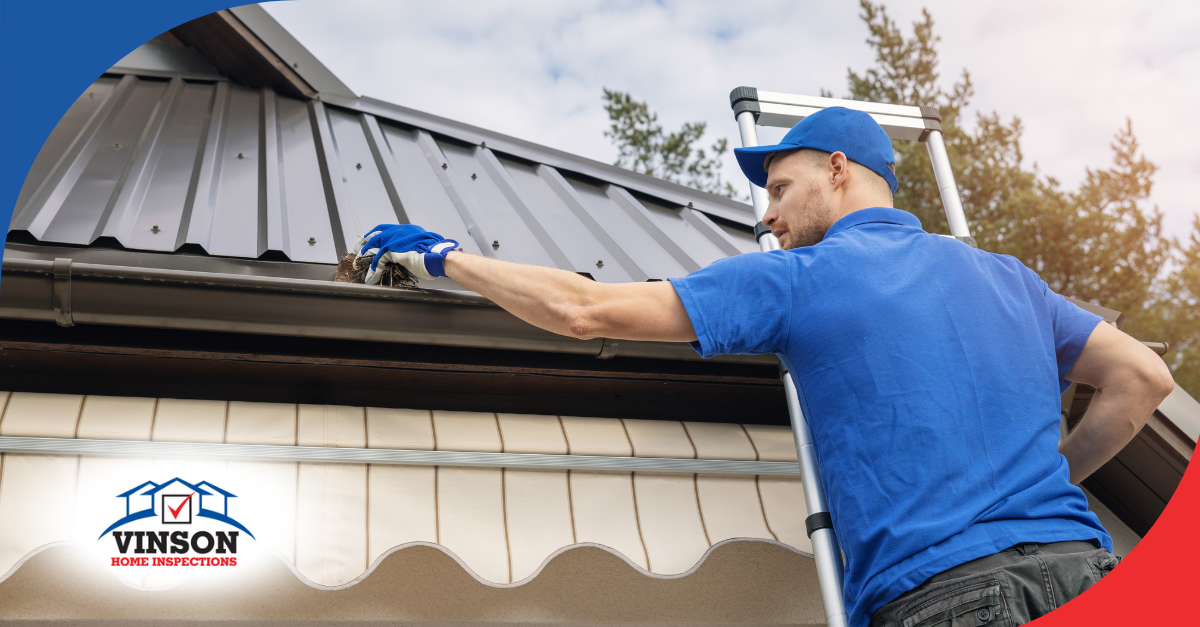 Worker cleaning debris from a home’s gutter.