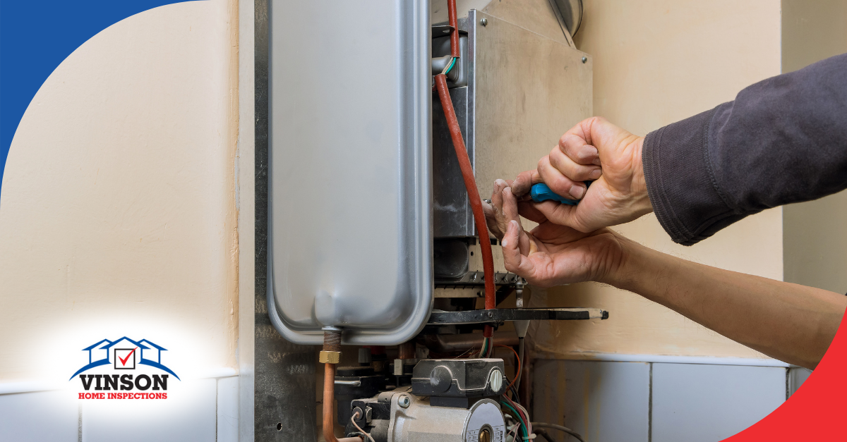 Technician repairing a wall-mounted water heater.